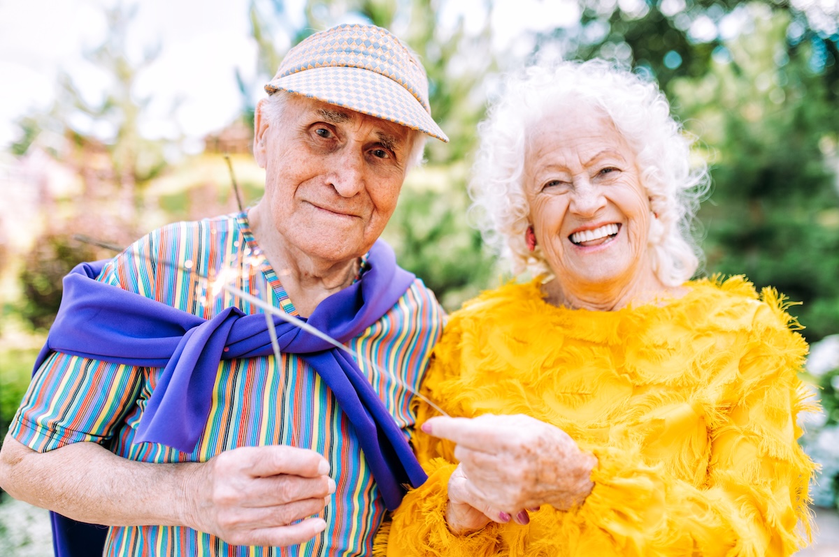 Old modern couple dressing fashionable colored clothes